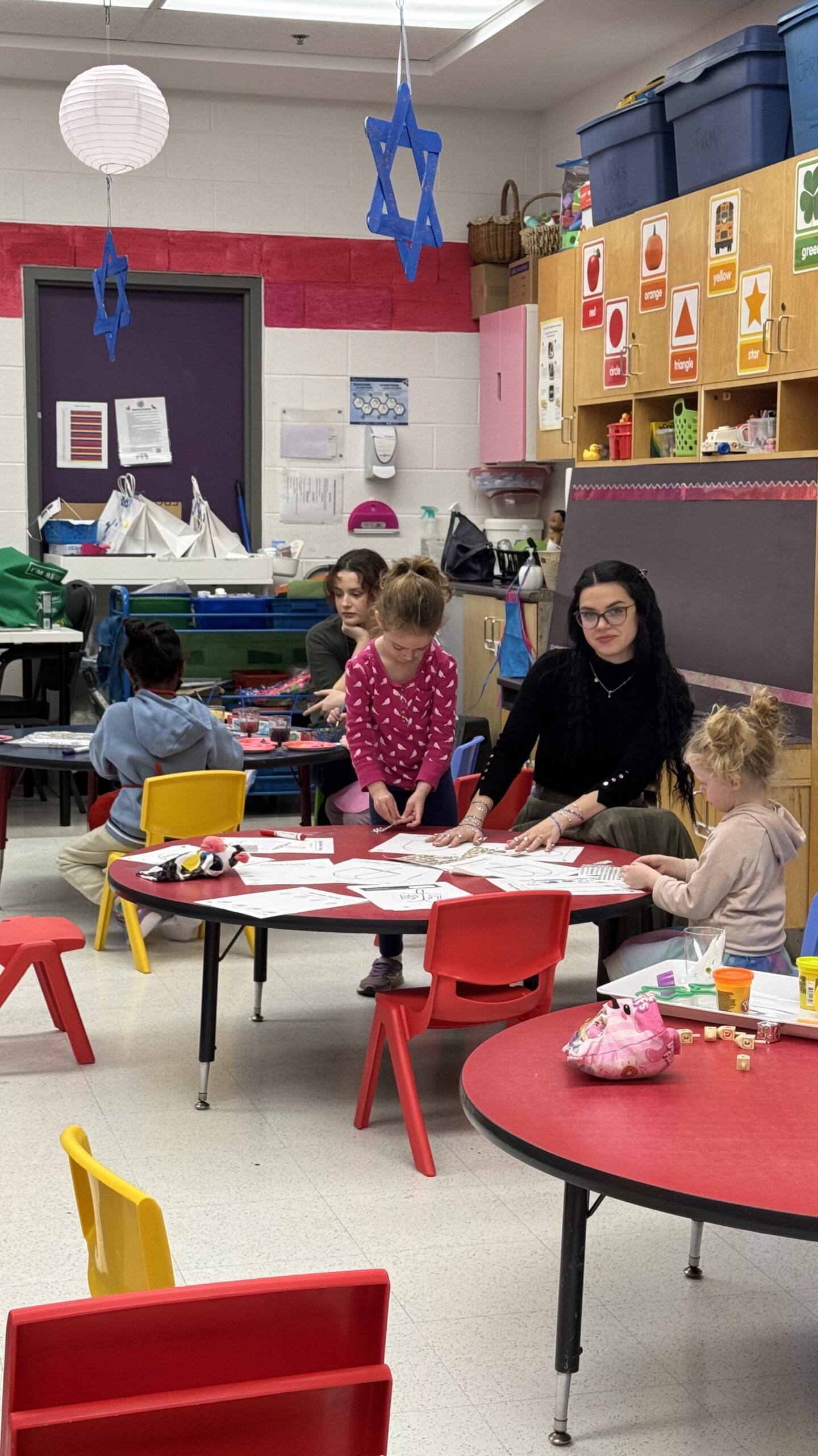 Young Sha’arim students learning with teachers during a classroom activity