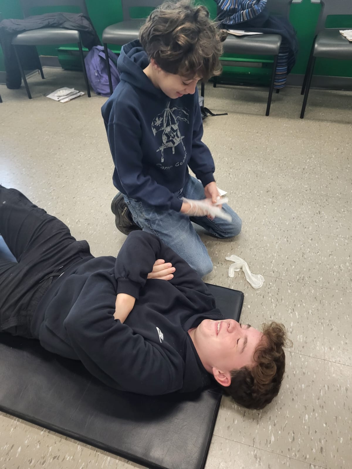 TeenShemet students practising first-aid bandaging techniques